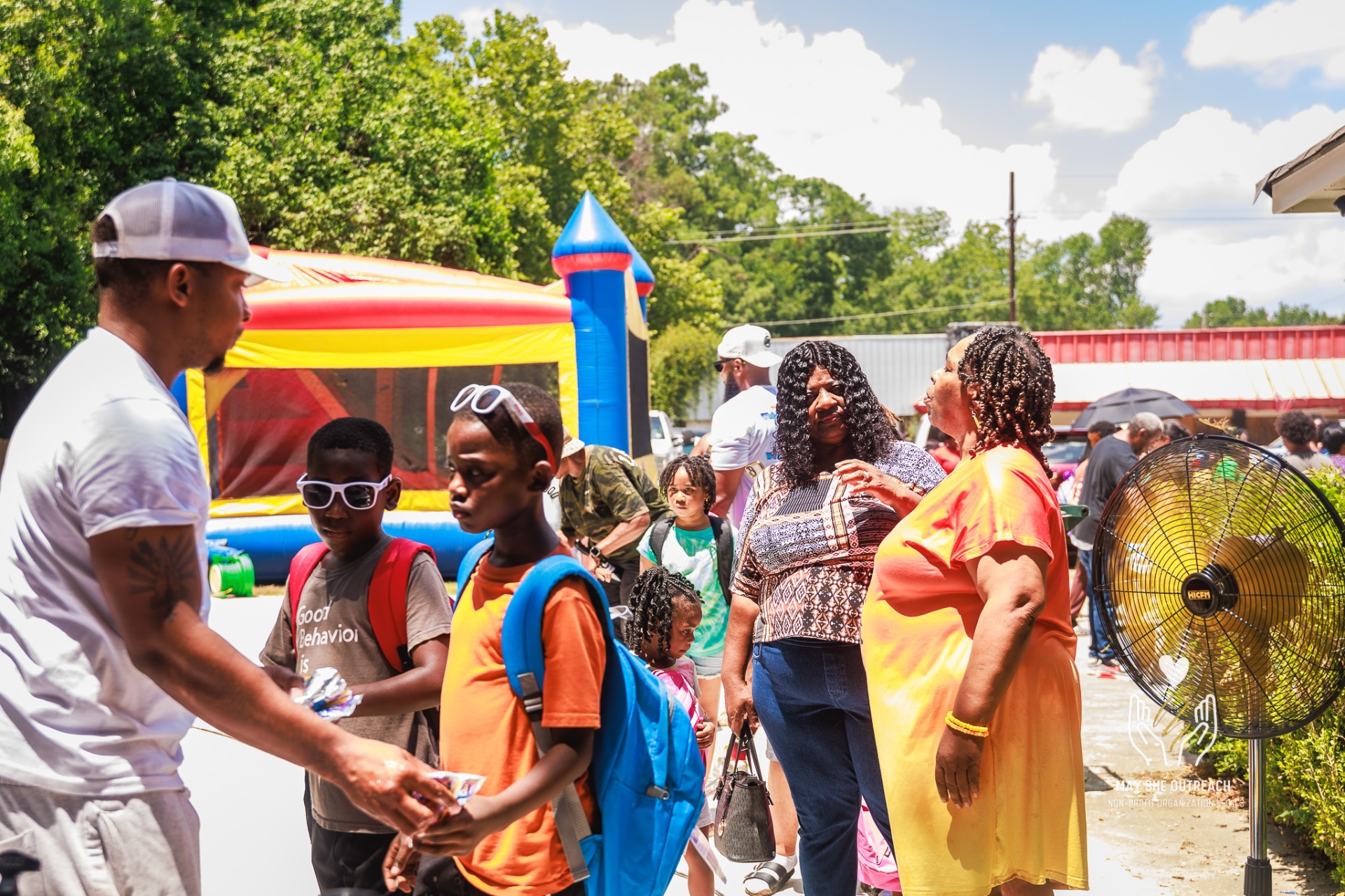 Children receiving backpacks at the back-to-school drive