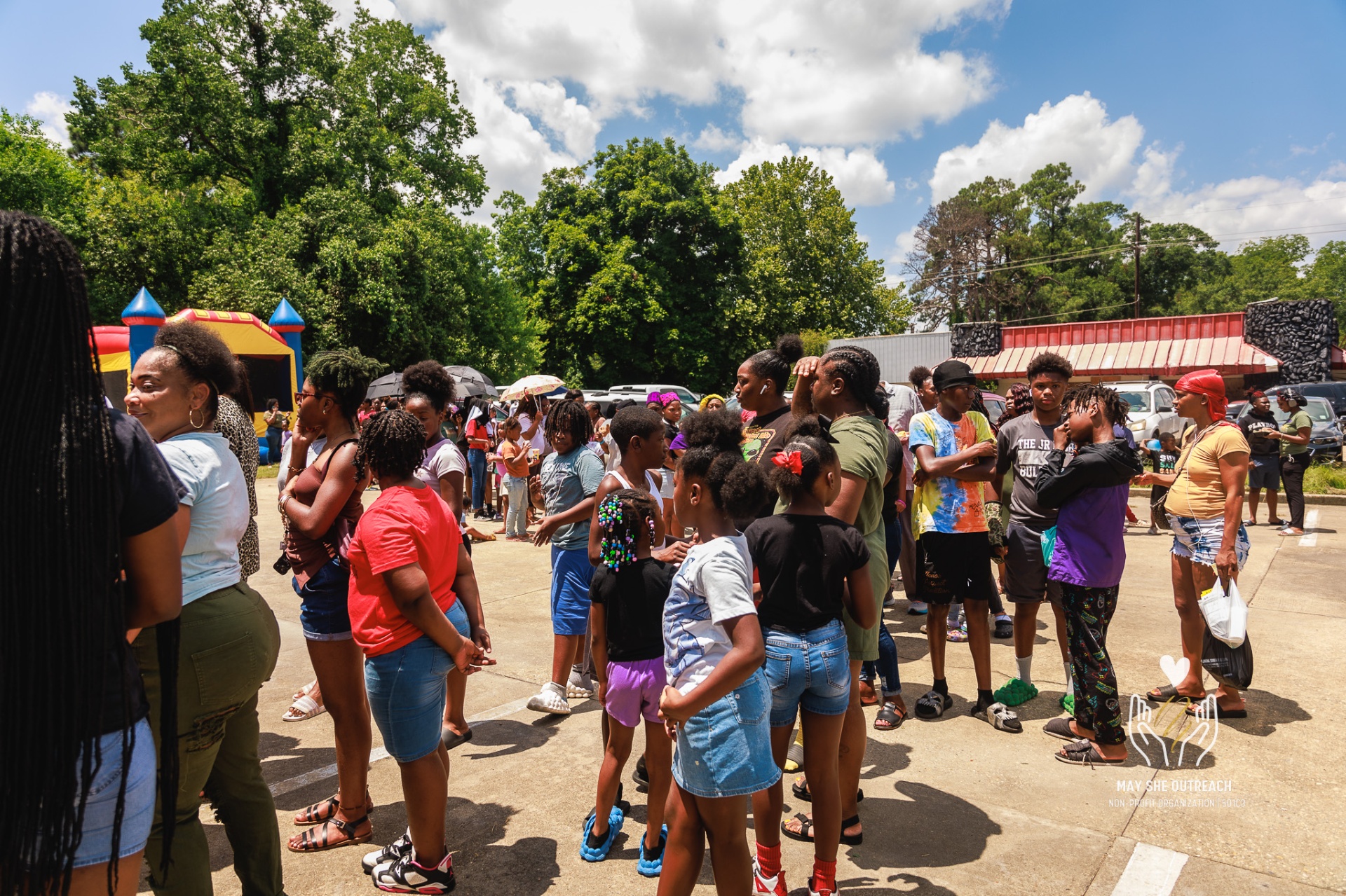 Families gathered at a May She Outreach community event